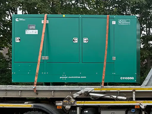 A Cummins C110D5Q 110kVA 3 phase silent canopied diesel generator set loaded on transport being collected by another UK generator supplier