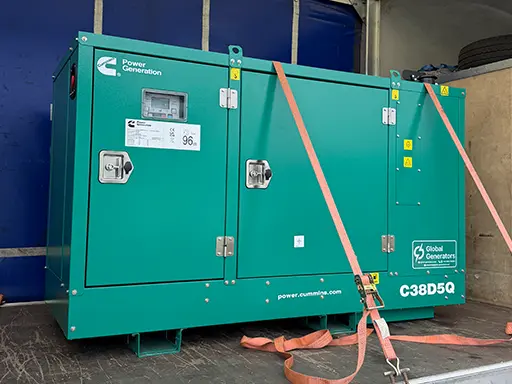 A Cummins C38D5Q 38kVA silent canopied diesel generator set loaded on transport for delivery to a UK groundwork, construction and landscaping company's headquarters and workshop in Buckinghamshire
