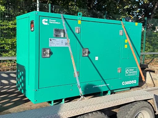 A Cummins C38D5Q 38kVA 3 phase silent canopied diesel generator loaded on a customer’s trailer ready for transport to off-grid solar-powered log cabins in Stoke-on-Trent, Staffordshire, UK